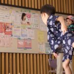 Elementary school students playing ring toss with seniors